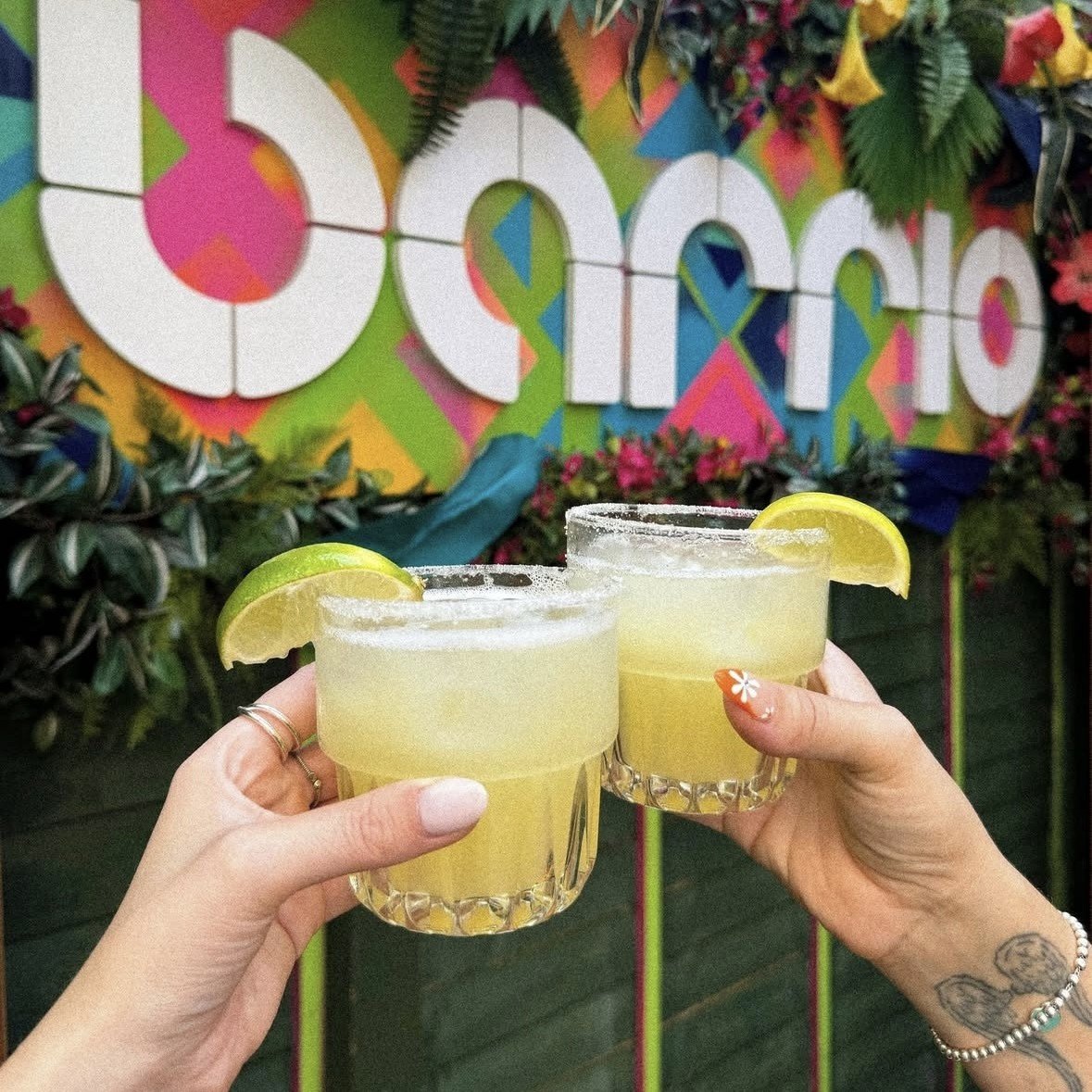 Guests holding Tommy's Margaritas outside in Barrio Shoreditch