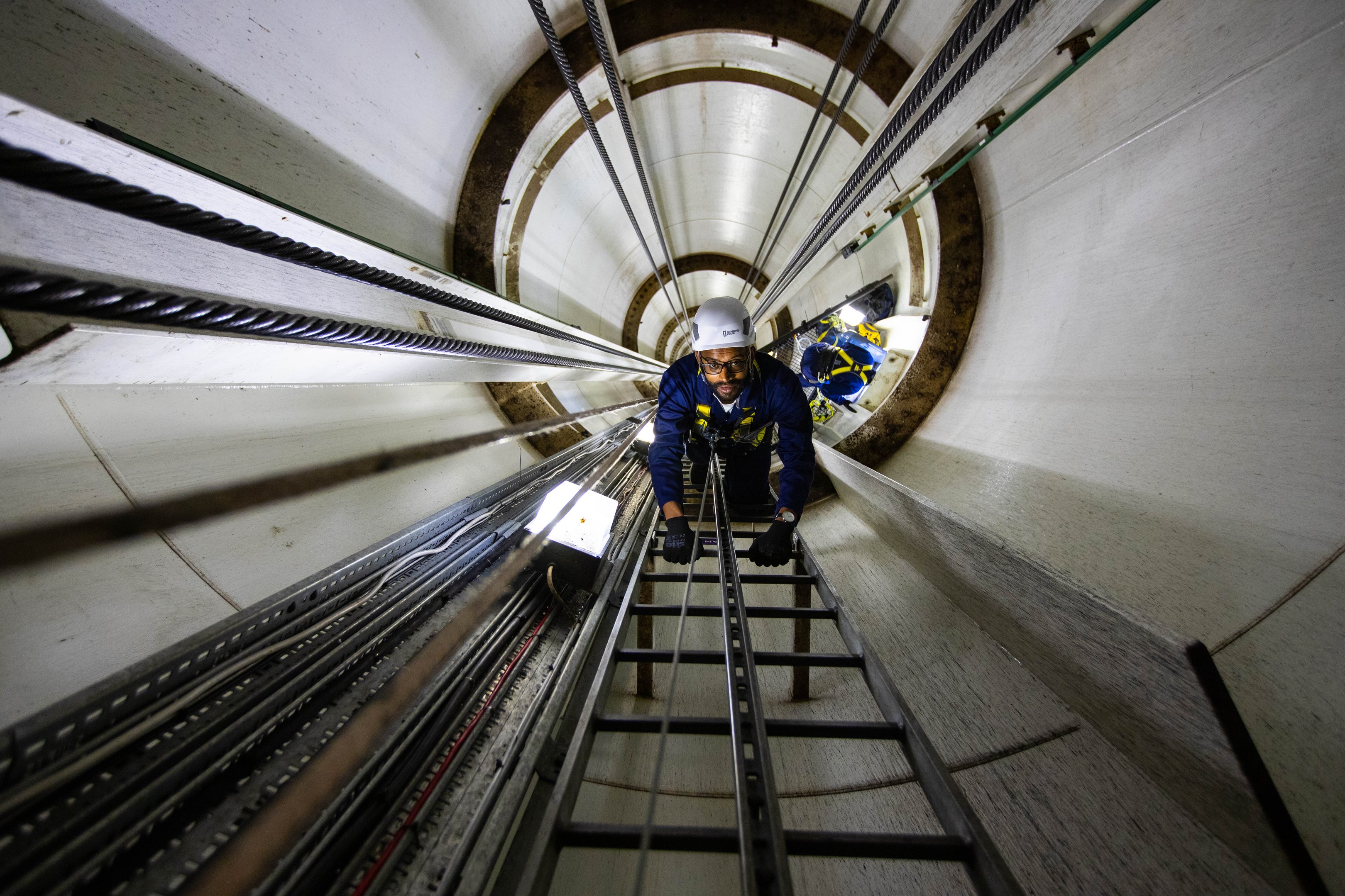 A guest climbing up the inside of the tower of the Brighton i360 as part of the Climb experience
