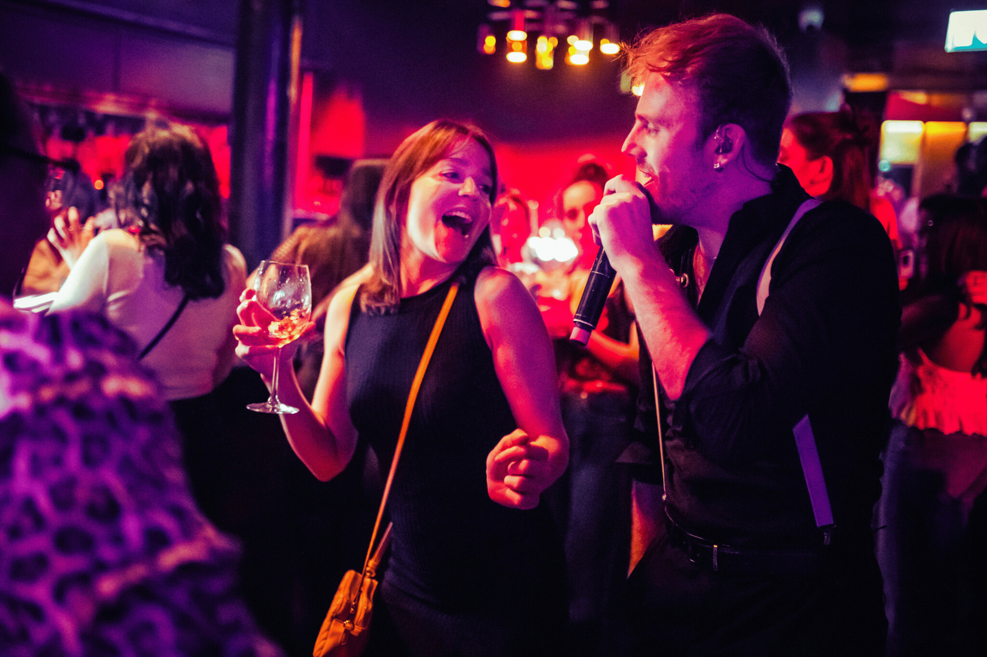 A guest dancing and singing along with a live performer in The Piano Works