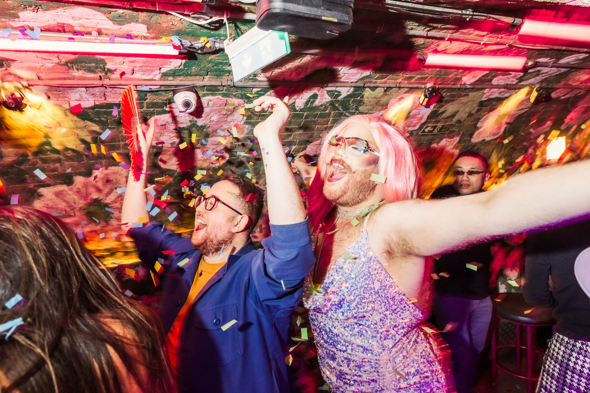 A drag artist and a customer singing and dancing in Blame Gloria at a bottomless brunch