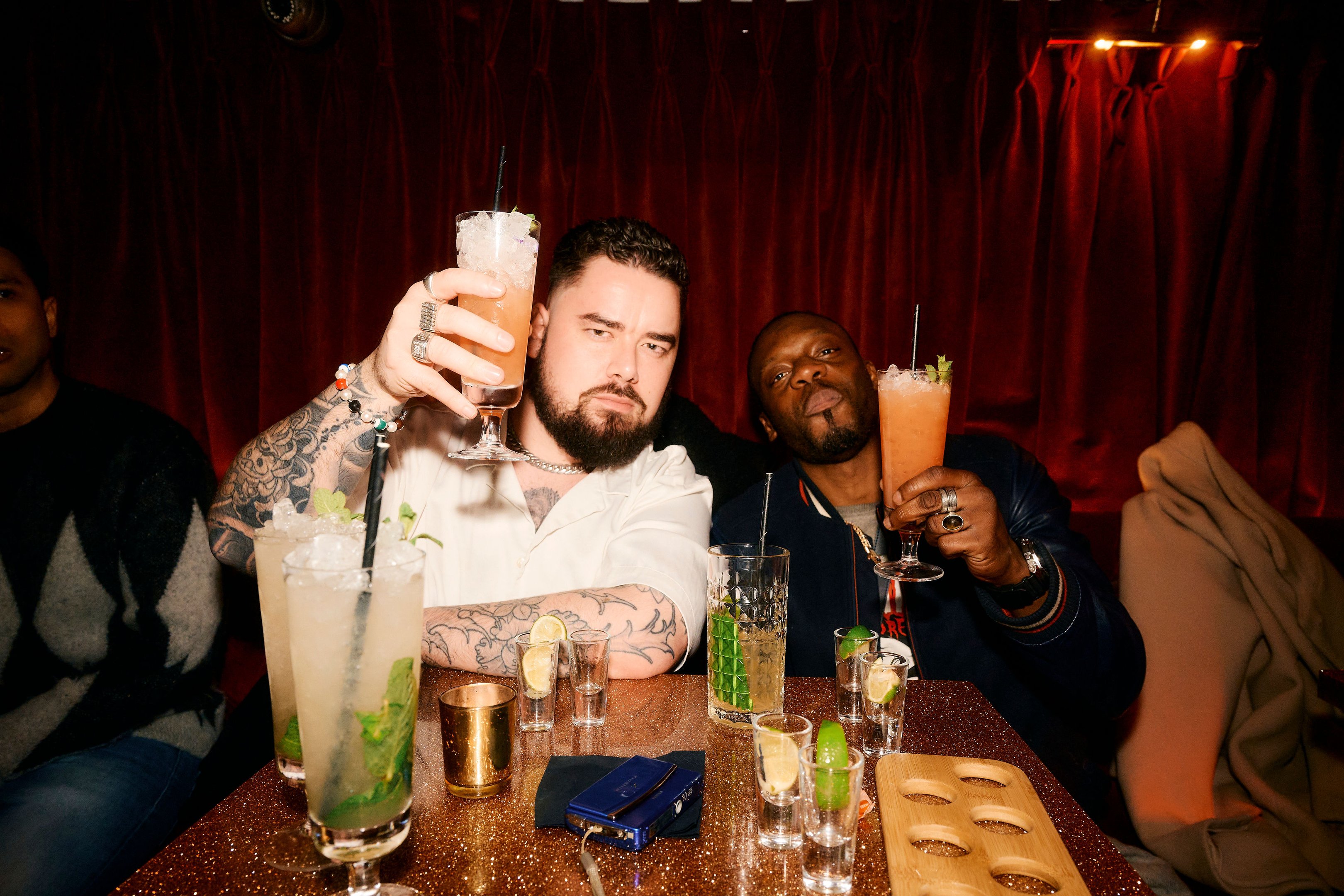 Two male guests sitting at a table in the Escapologist and enjoying cocktails