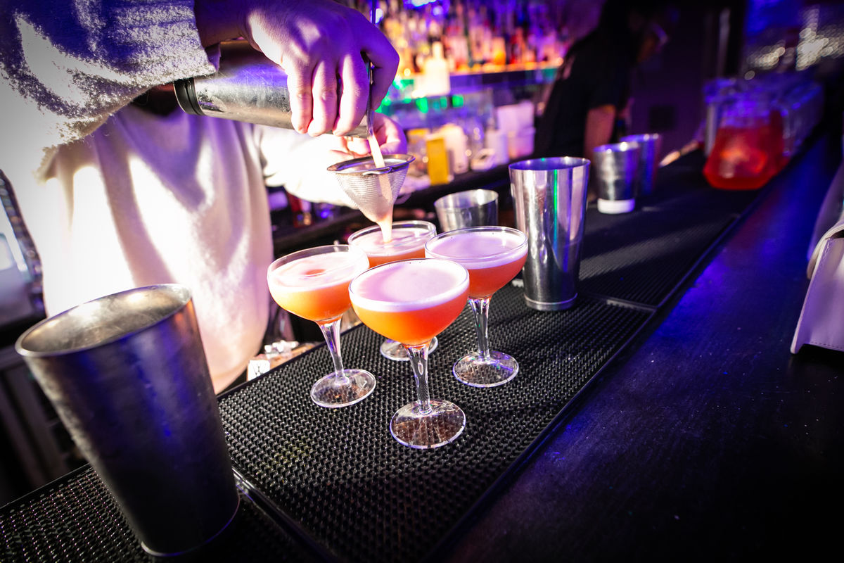 A barman pouring Pornstar Martini cocktails on the bar in Tonight Josephine