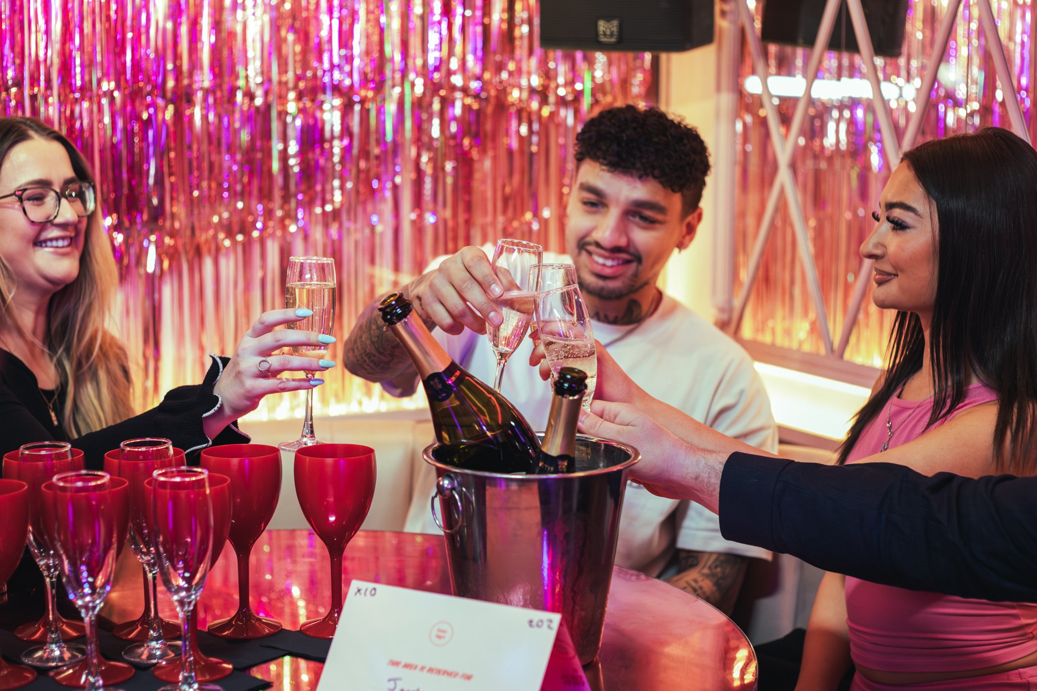 Guests clinking their prosecco glasses at a table ready for a bottomless brunch in Tonight Josephine