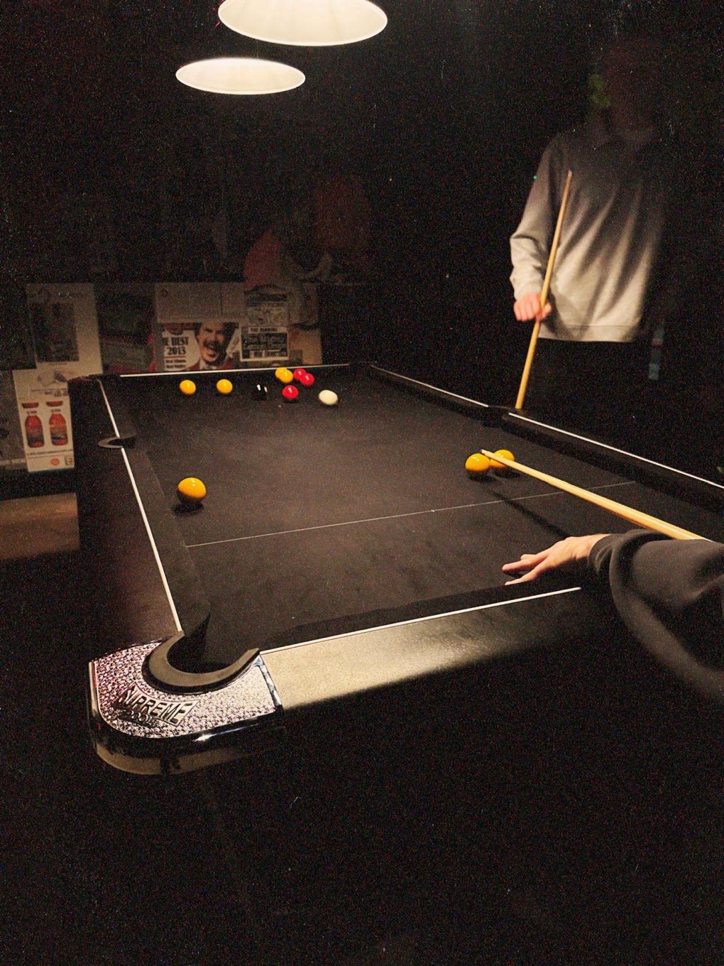 A pool table being played on in Afters bar