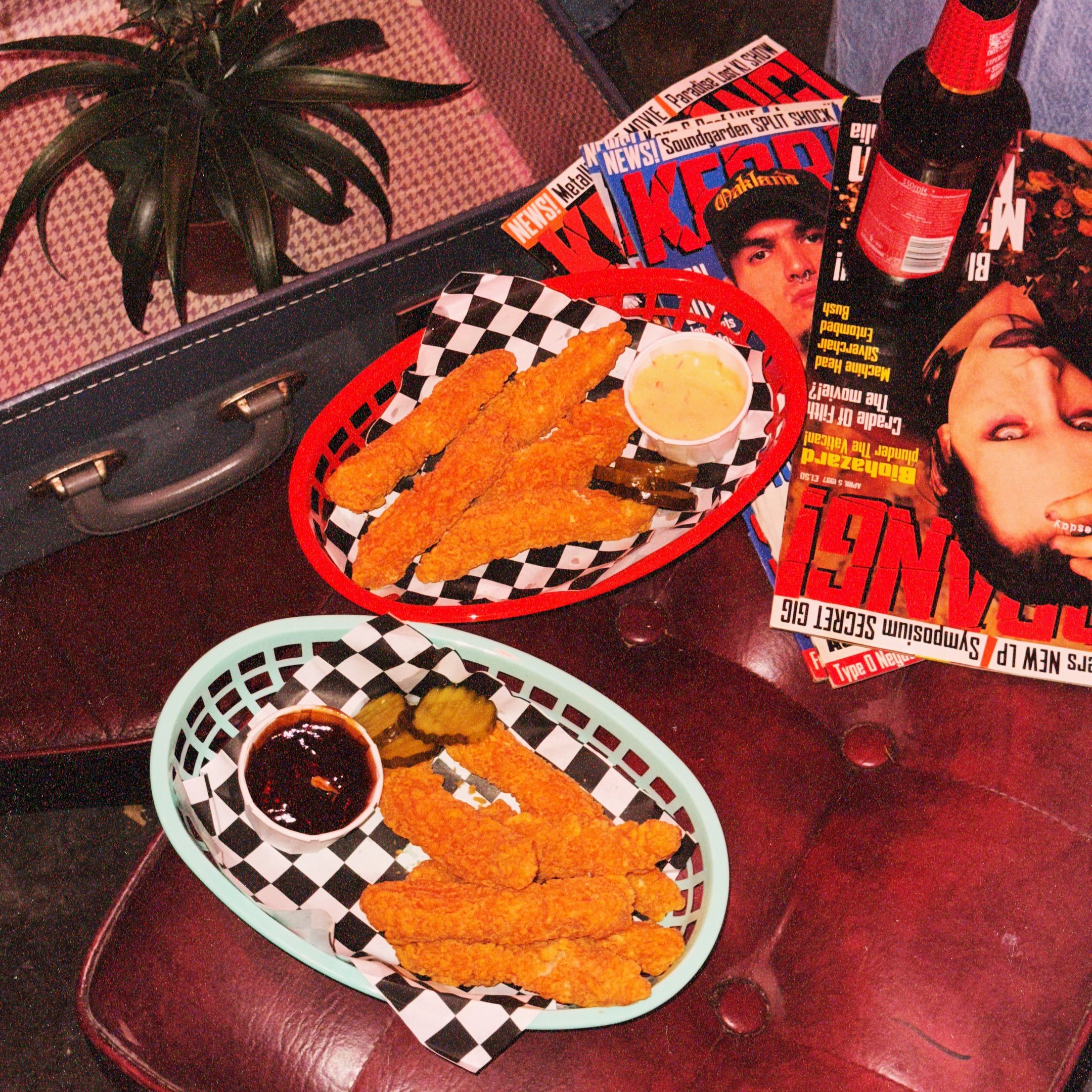 Chicken tenders in a basket with dipping sauces in Afters