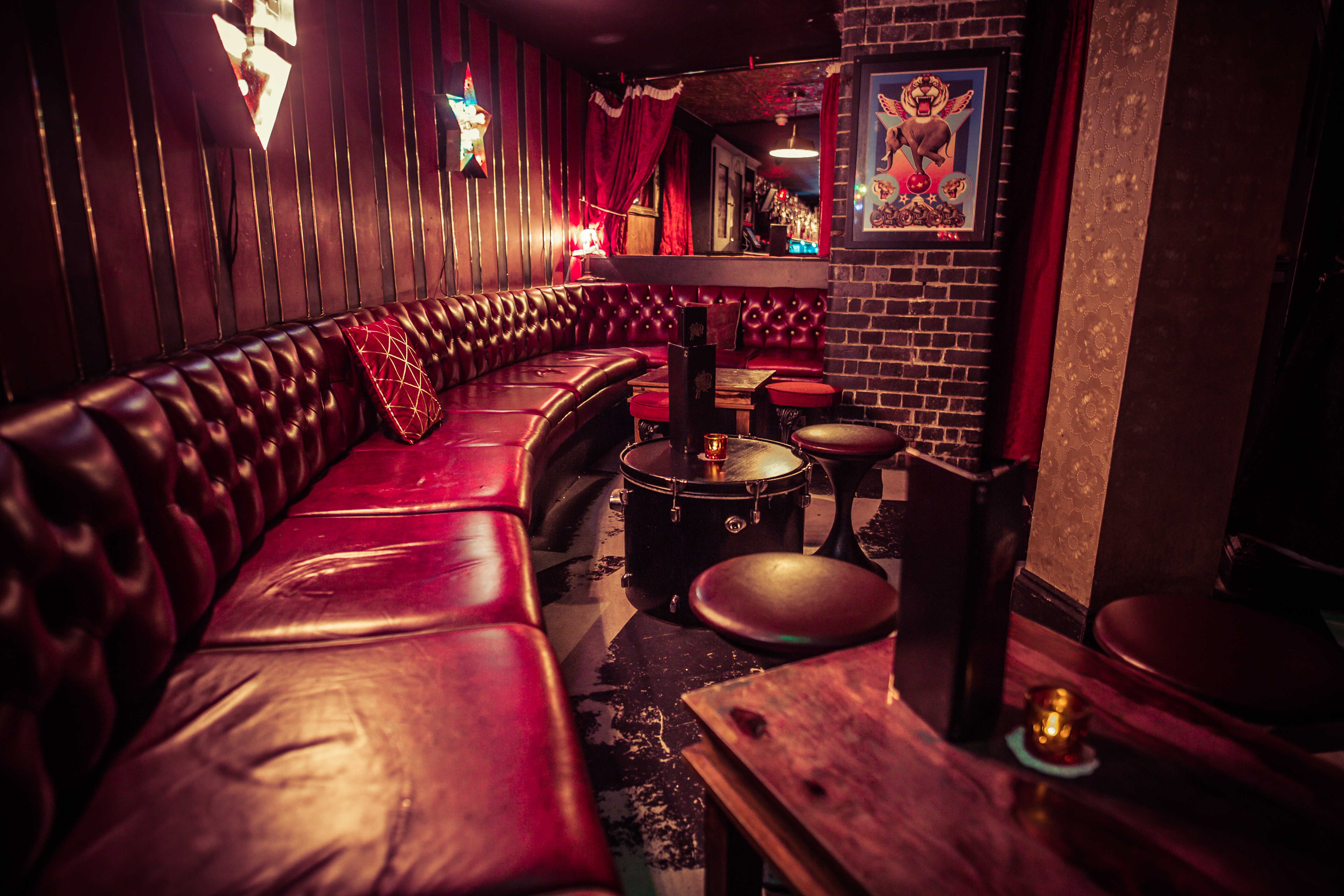 Red leather booth seating and exposed brick walls with light up artwork