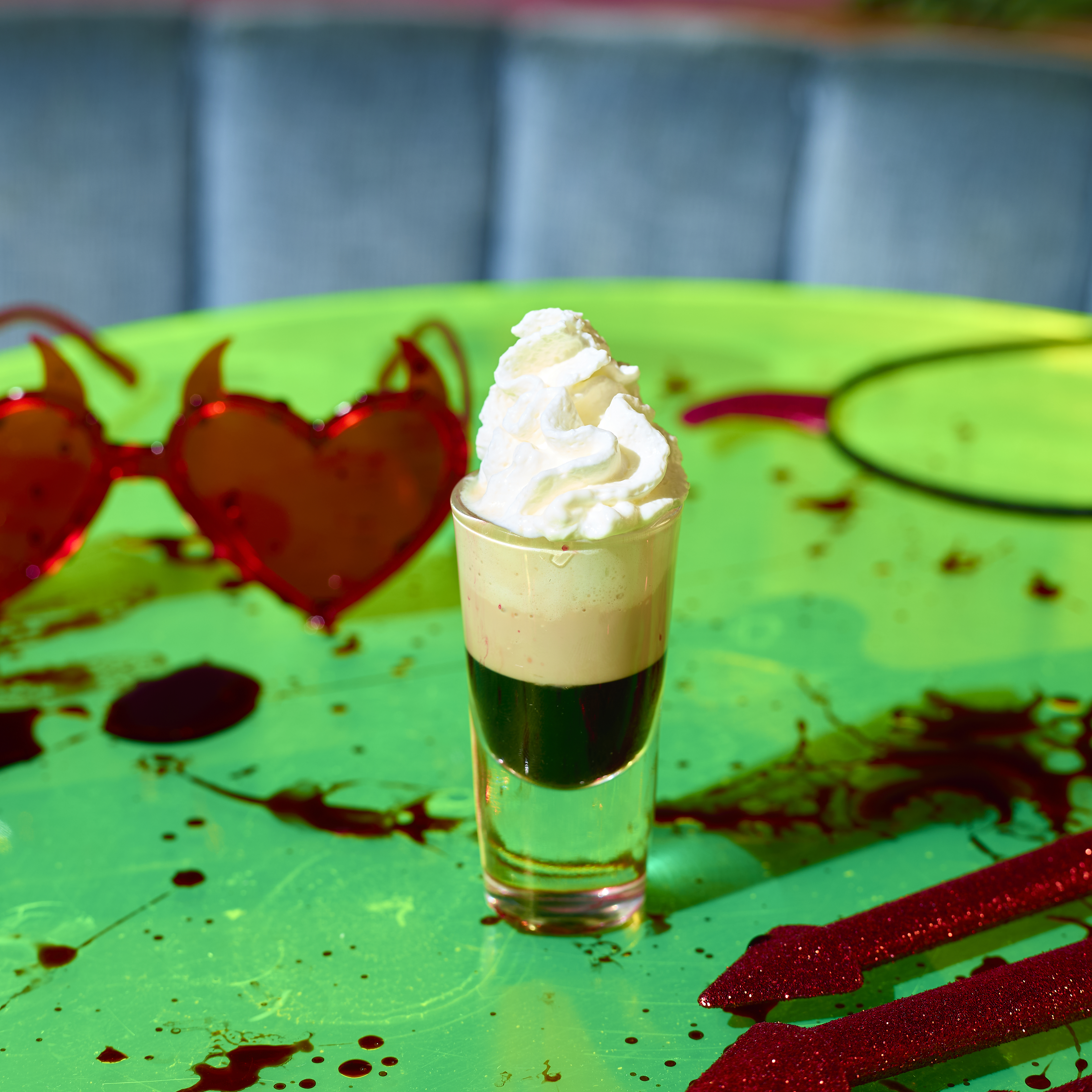 Image of a layered Halloween shot with whipped cream on top at Nikki's Bar